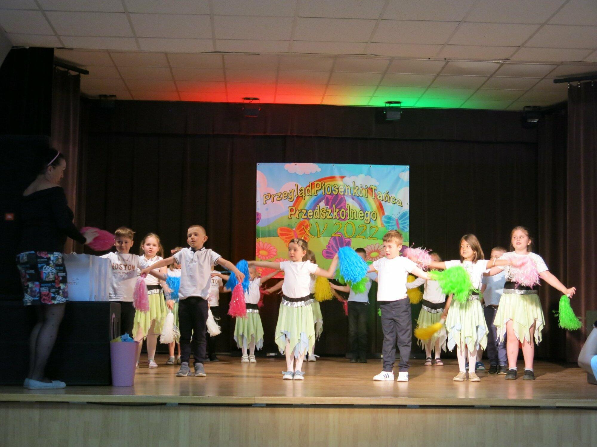 Tańczące dzieci z kolorowymi pomponami